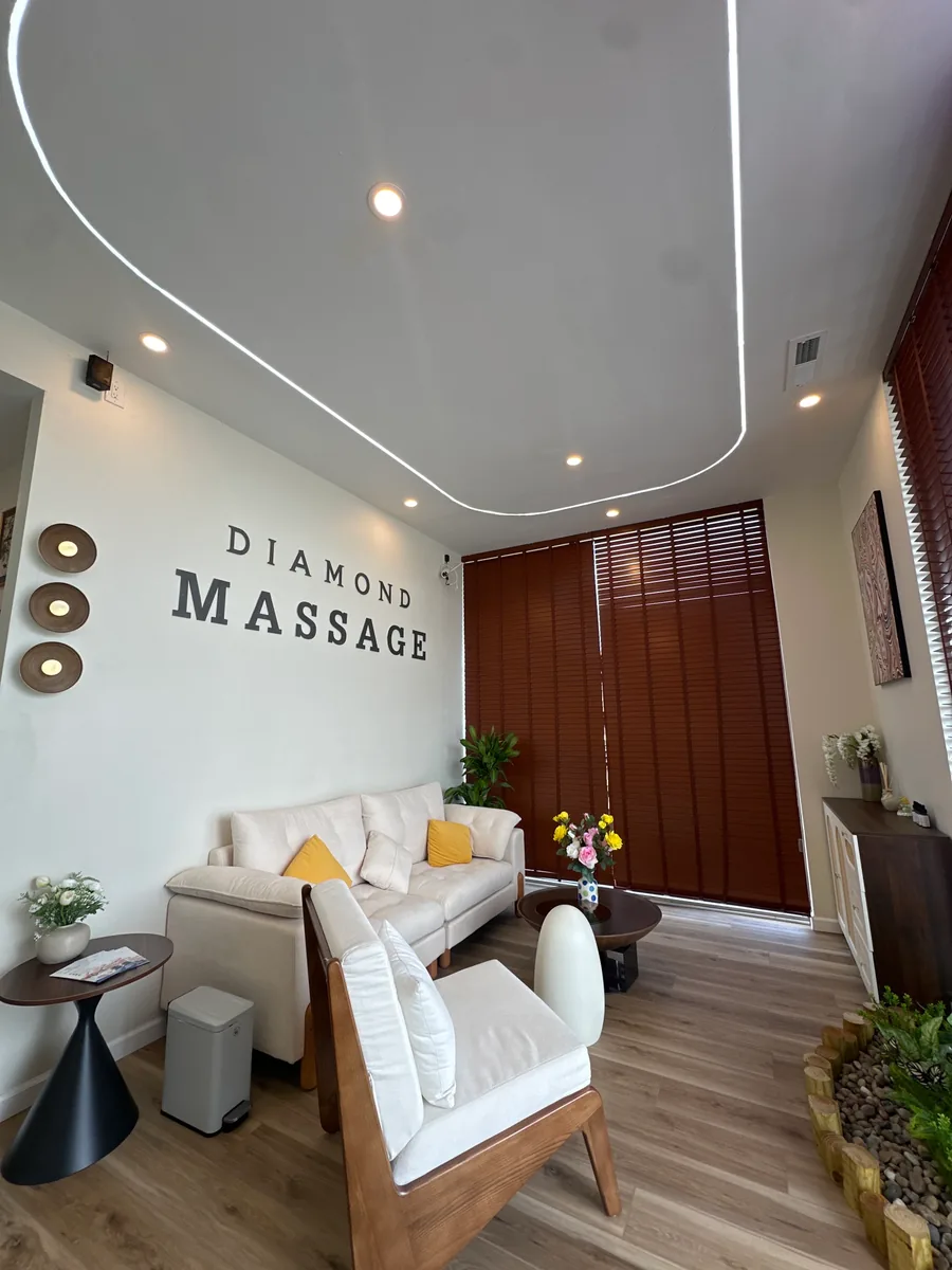 the lounge at Diamond Massage seen from the door, DIAMOND MASSAGE lettering on the wall above a cream sofa
